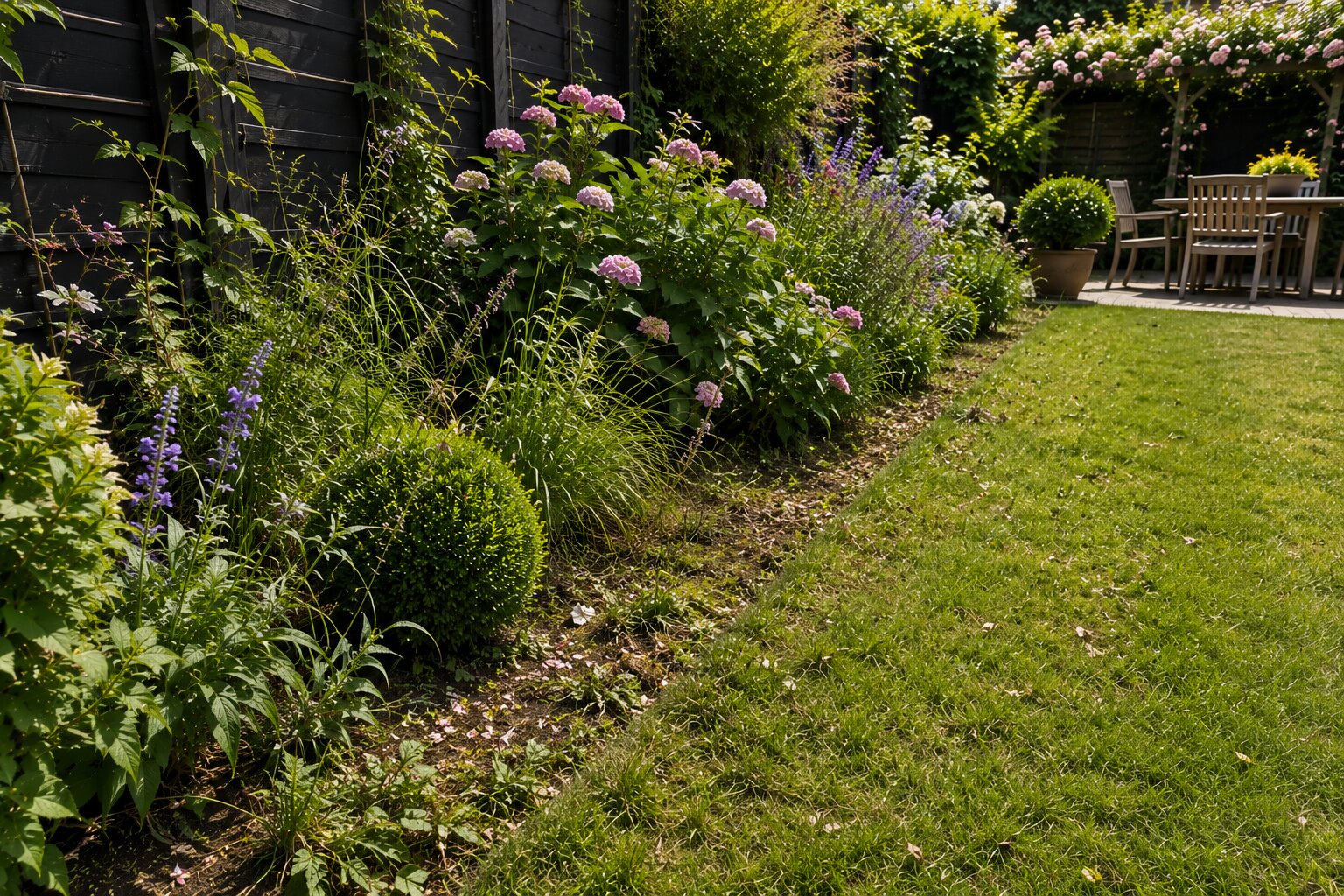Detail of established garden border before maintenance, with untidy growth and seasonal debris.